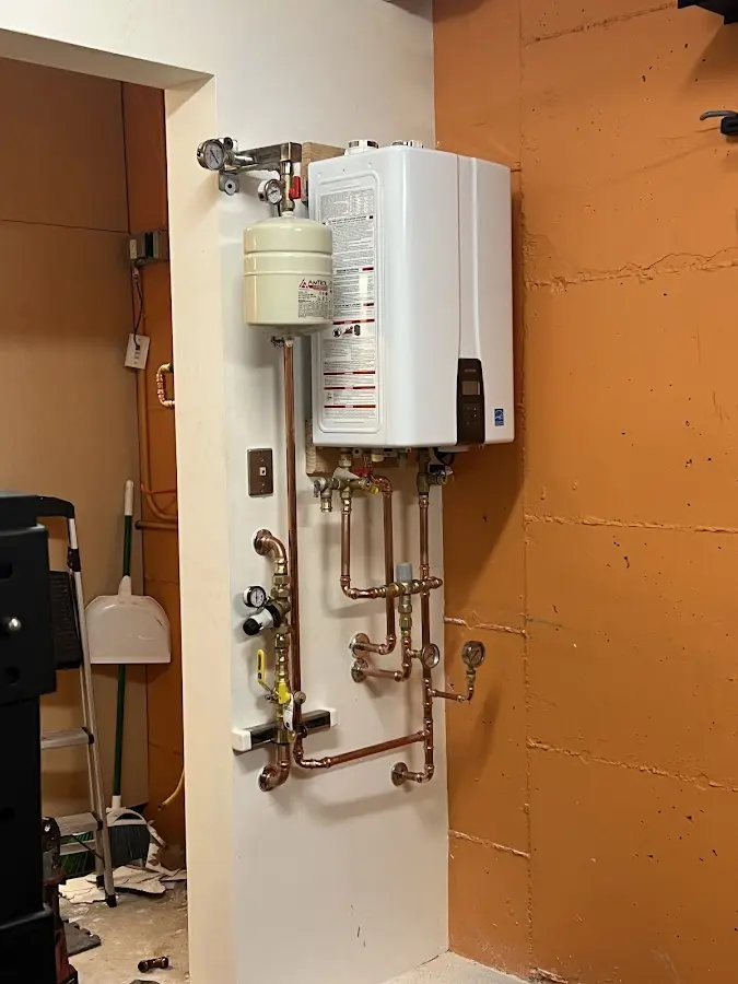 Plumbing technician inspecting water heater connections in El Segundo